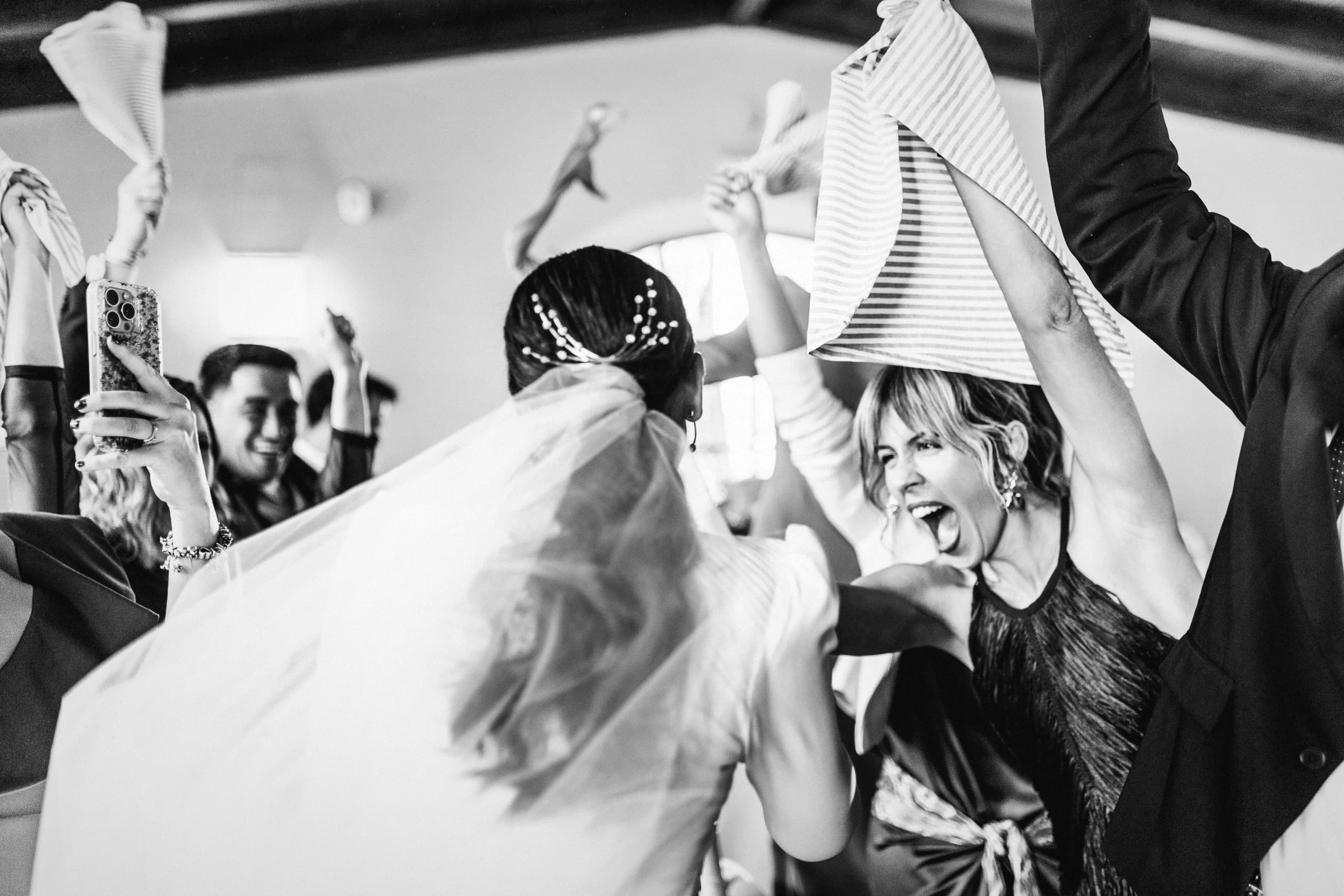 Invitados celebrando y agitando servilletas en la fiesta