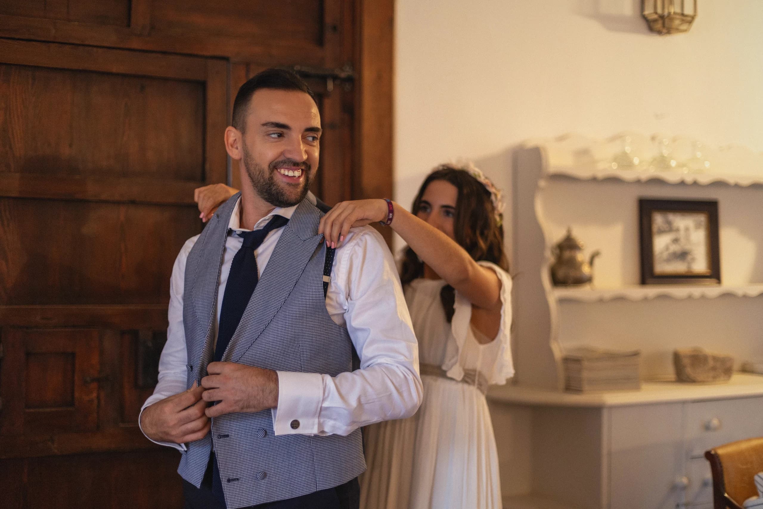 El novio ajustándose el chaleco con su madre