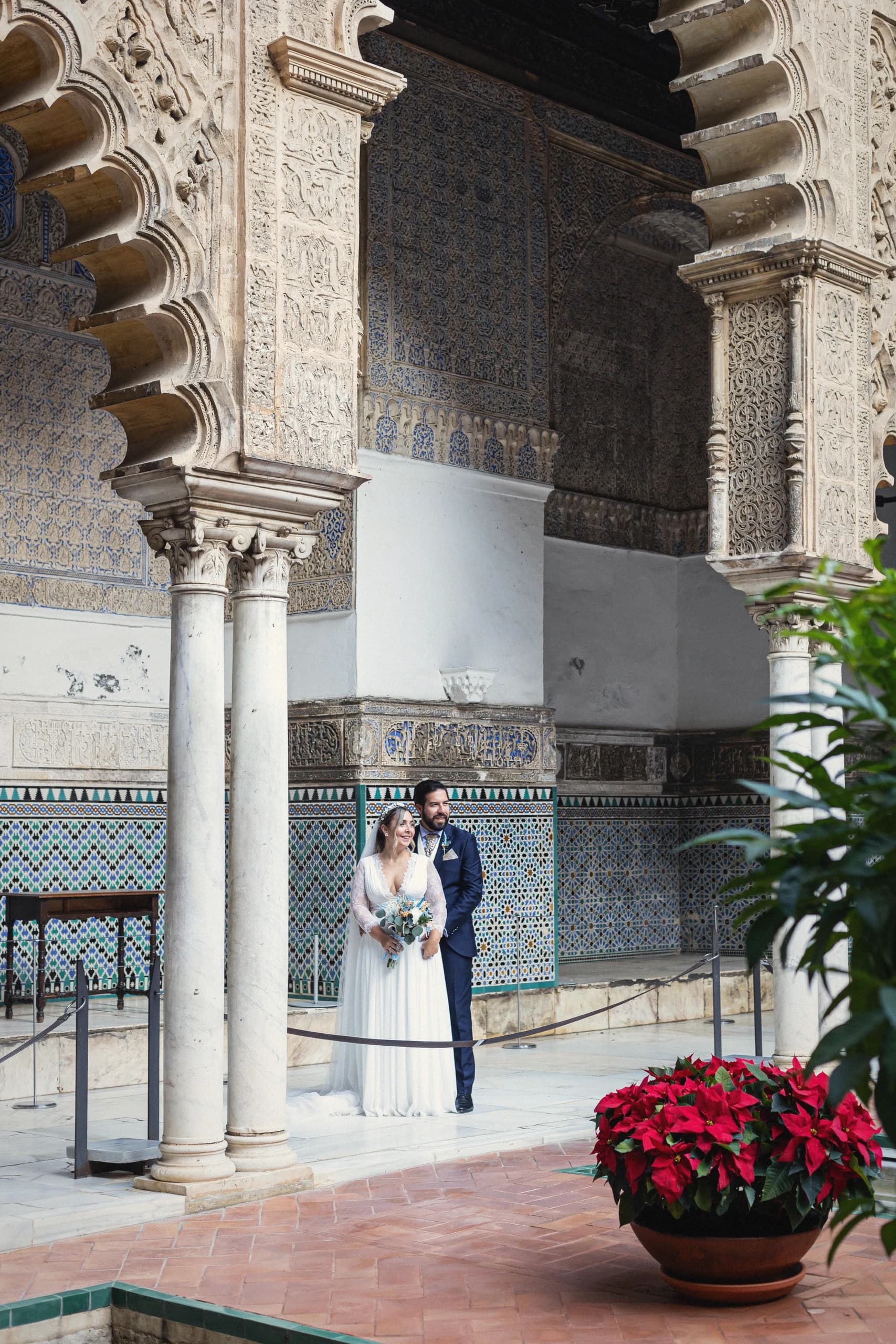 La pareja entre las columnas de mármol y los azulejos del patio