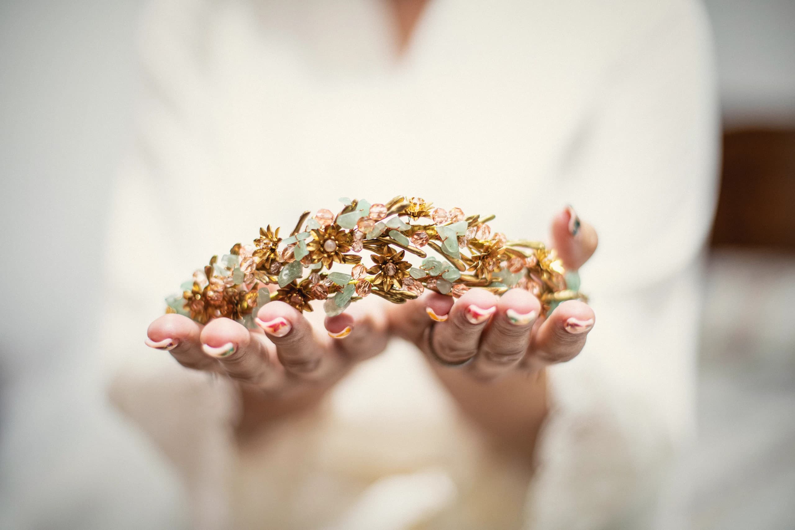 El tocado dorado en las manos de la novia