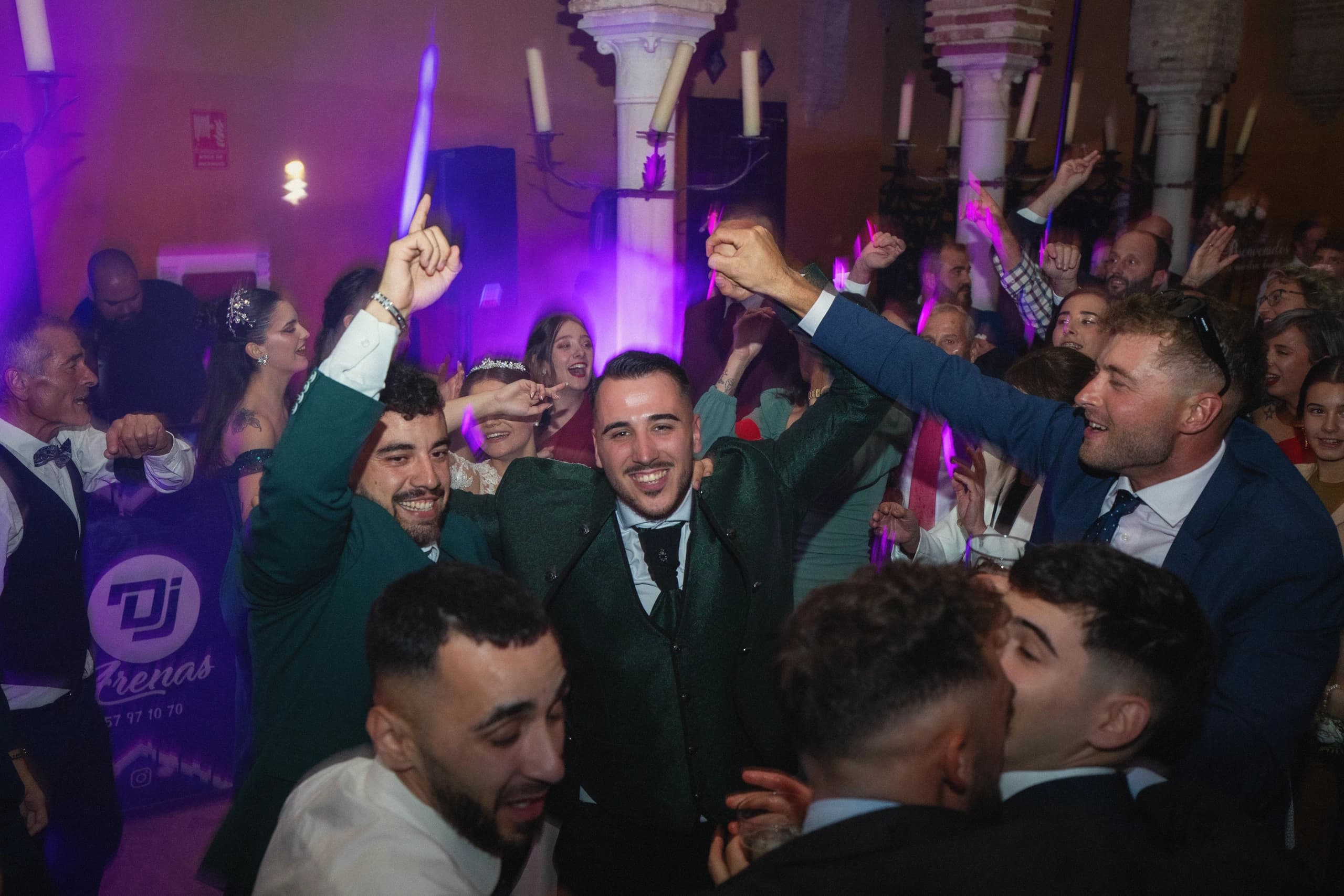 La fiesta con luces moradas y el novio entre sus amigos