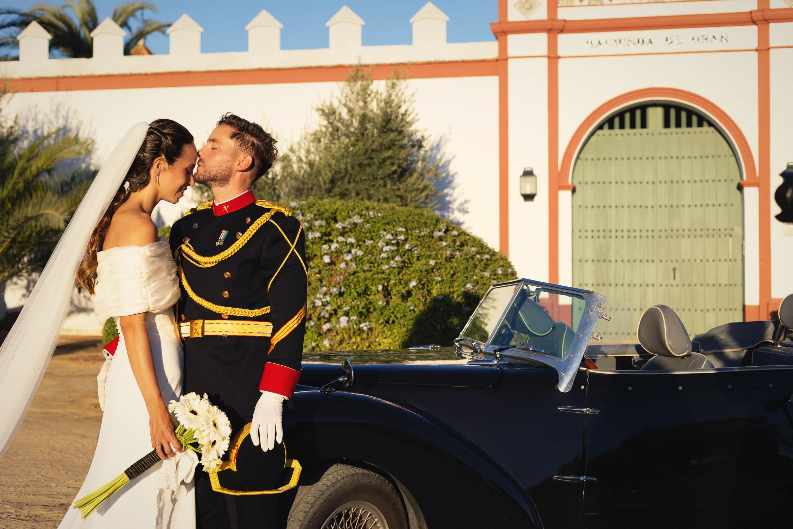 El beso de los novios junto al coche clásico