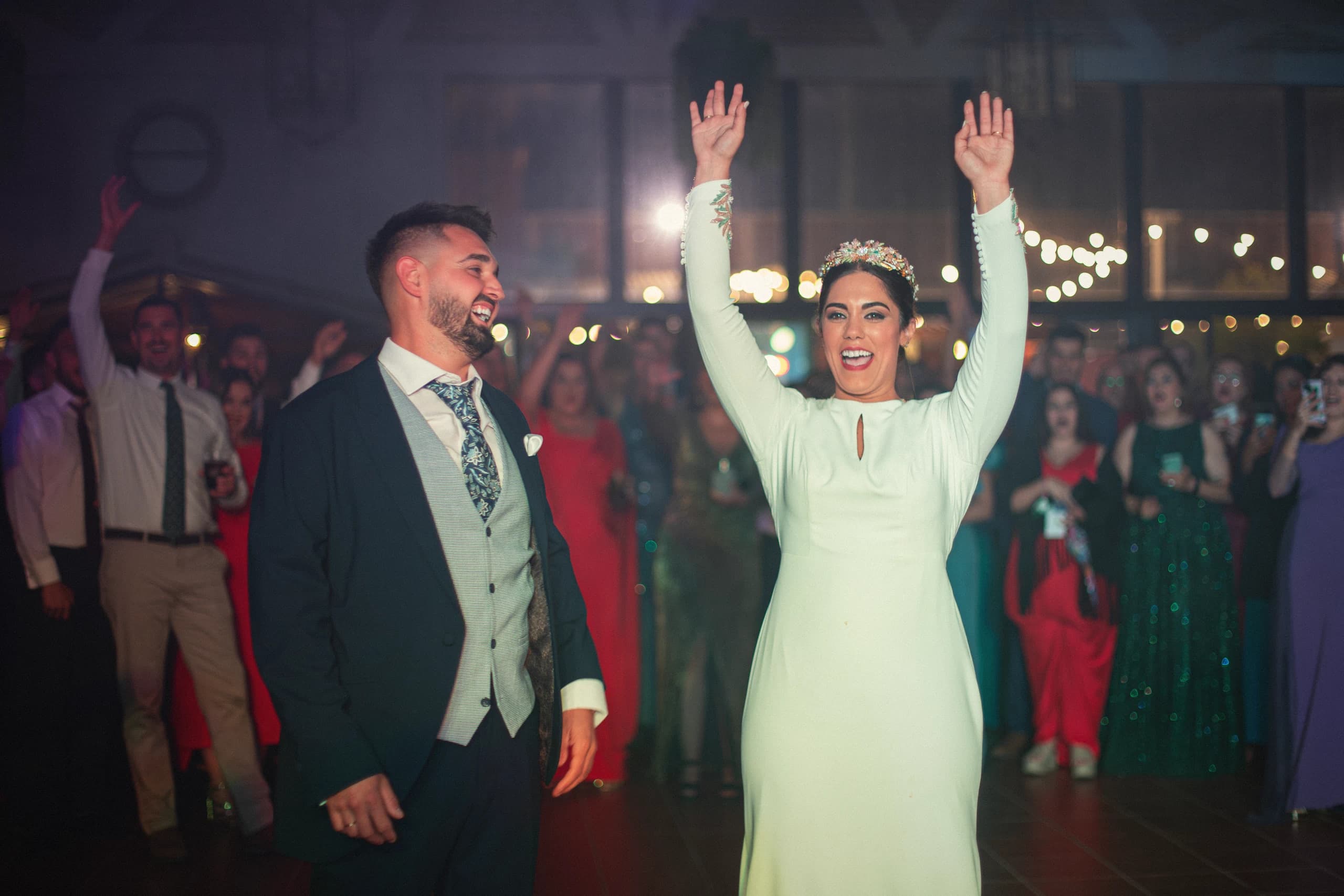 Los novios con los brazos en alto en la pista